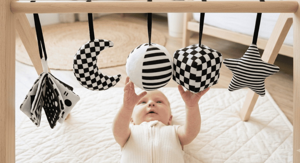Baby activity gym with black and white high-contrast hanging toys